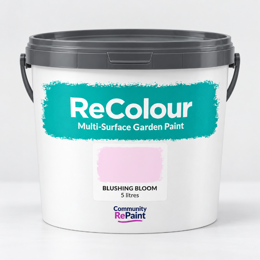 A 5-liter bucket of ReColour Multi-Surface Garden Paint in the shade Blushing Bloom, featuring a white bucket with a dark gray lid and a teal label showing a pink color swatch.